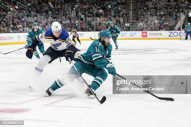 Luke Kunin of the San Jose Sharks skating with the puck against the St. Louis Blues at SAP Center on April 6, 2024 in San Jose, California.