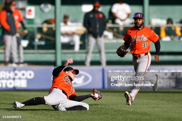 Baltimore Orioles outfielder Austin Hays tries to make a sliding catch but drops the ball during an MLB game against the Pittsburgh Pirates on April...