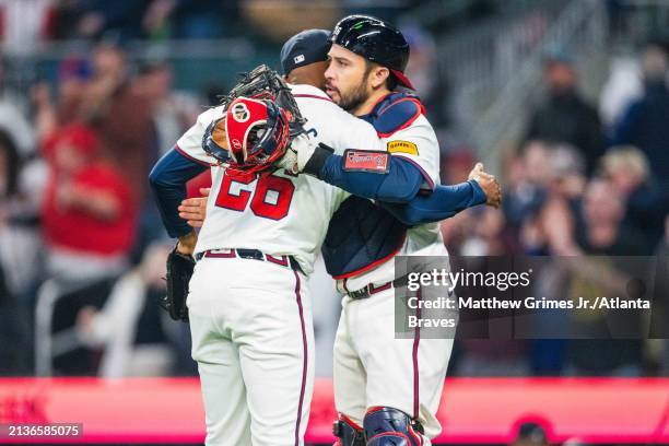 Raisel Iglesias and Travis d'Arnaud of the Atlanta Braves celebrate after the win against the Arizona Diamondbacks at Truist Park on April 6, 2024 in...