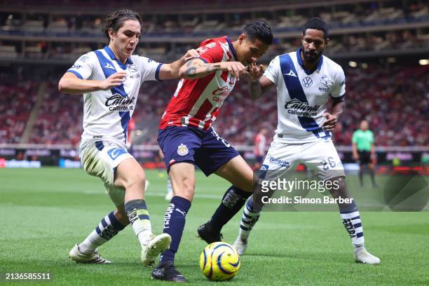 Carlos Cisneros of Chivas fights for the ball with Alberto Herrera and Brayan Angulo of Puebla during the 14th round match between Chivas and Puebla...
