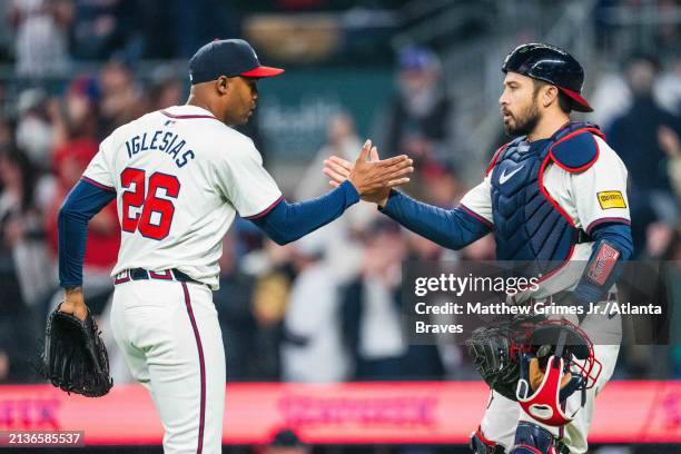 Raisel Iglesias and Travis d'Arnaud of the Atlanta Braves celebrate after the win against the Arizona Diamondbacks at Truist Park on April 6, 2024 in...