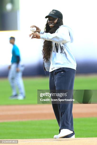 Dallas Wings guard Arike Ogunbowale throws out a ceremonial first pitch during a game between the Milwaukee Brewers and the Seattle Mariners at...