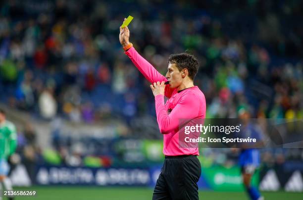 Referee hands out a yellow card during a MLS matchup between CF Montréal and the Seattle Sounders on April 6, 2024 at Lumen Field in Seattle, WA.