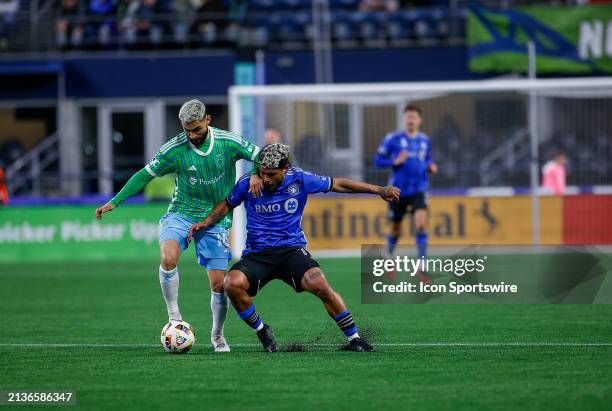 Seattle Sounders midfielder Alex Roldan fights for control of the ball over CF Montréal forward Josef Martínez during a MLS matchup between CF...