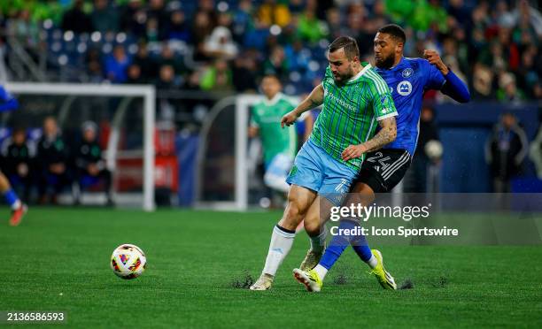 Montréal defender George Campbell kicks the ball away from Seattle Sounders forward Jordan Morris during a MLS matchup between CF Montréal and the...