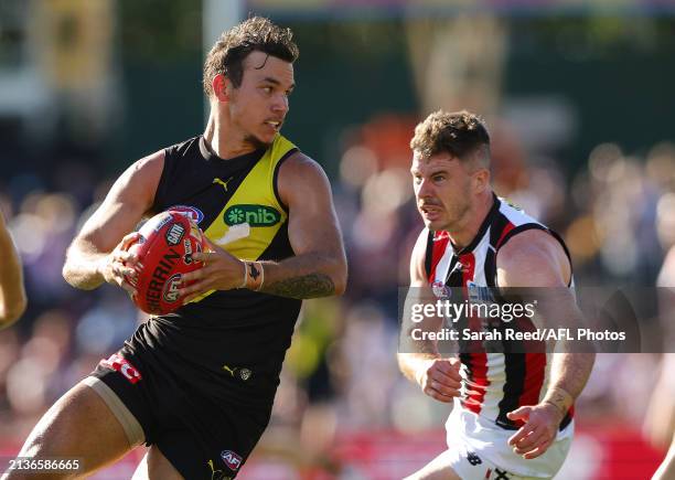 Daniel Rioli of the Tigers and Jack Higgins of the Saints during the 2024 AFL Round 04 match between the Richmond Tigers and the St Kilda Saints at...