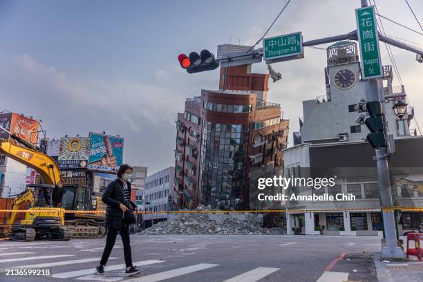 Person walks past an area of a damaged building is cordoned off following the earthquake on April 04, 2024 in Hualien, Taiwan. A 7.5 magnitude...