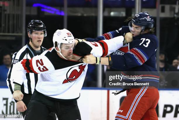 Kurtis MacDermid of the New Jersey Devils fights with Matt Rempe of the New York Rangers during the first period at Madison Square Garden on April...