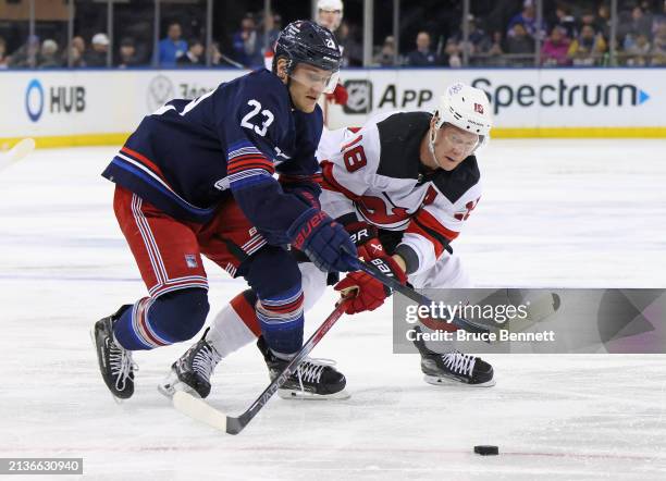 Adam Fox of the New York Rangers and Ondrej Palat of the New Jersey Devils battle for the puck during the first period at Madison Square Garden on...