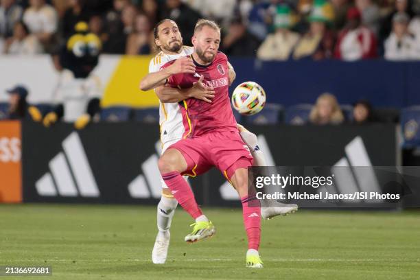 Joao Klauss of St. Louis City SC battles with Martin Caceres of the LA Galaxy for a loose ball during an MLS regular season match between St. Louis...