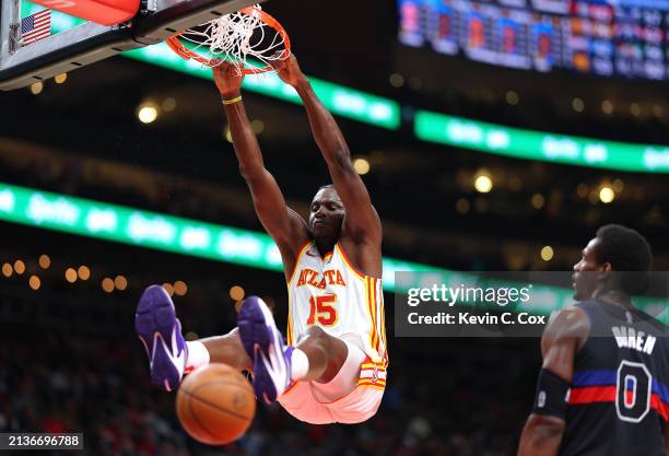 Clint Capela of the Atlanta Hawks dunks against Jalen Duren of the Detroit Pistons during the second quarter at State Farm Arena on April 03, 2024 in...