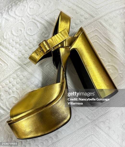 gold-colored high heeled shoes - platform shoe stock pictures, royalty-free photos & images