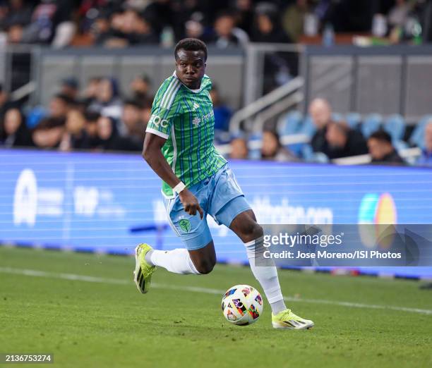 Nouhou Tolo of Seattle Sounders dribbles the ball through the left wing and looks for a centering pass during a game between Seattle Sounders FC and...