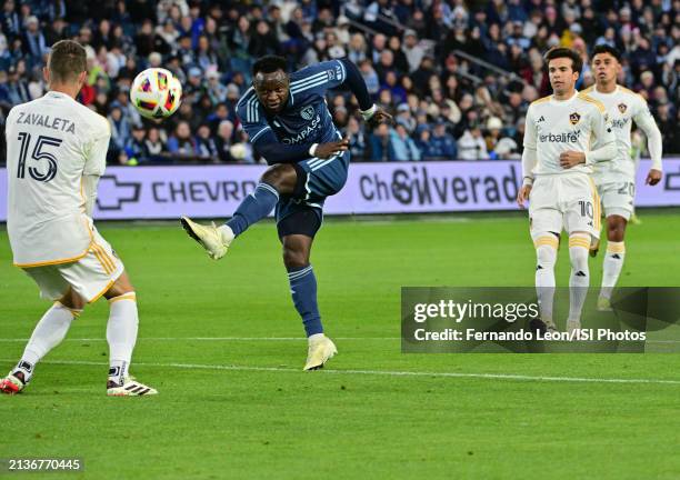 Willy Agada of Sporting Kansas City shoots on goal as Eriq Zavaleta of LA Galaxy braces himself during a game between Los Angeles Galaxy and Sporting...