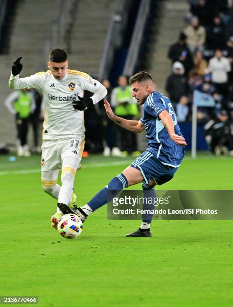 Gabriel Pec of LA Galaxy and Remi Walter of Sporting Kansas City battle for possession of the ball during a game between Los Angeles Galaxy and...
