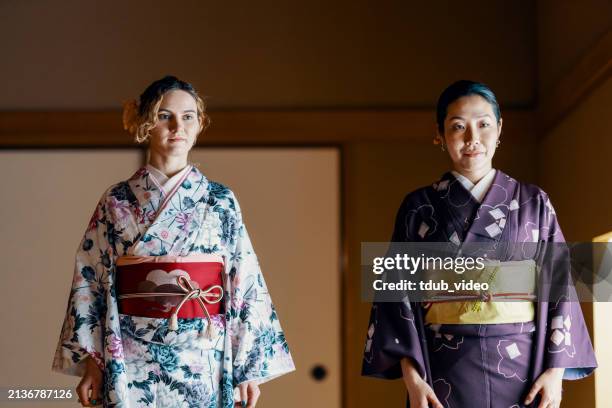 deux touristes tentent une expérience de kimono dans un sanctuaire au japon - kimono photos et images de collection