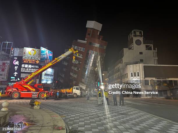 Rescuers search for individuals trapped in a severely tilted building after a 7.3-magnitude earthquake on April 3, 2024 in Hualien County, Taiwan of...