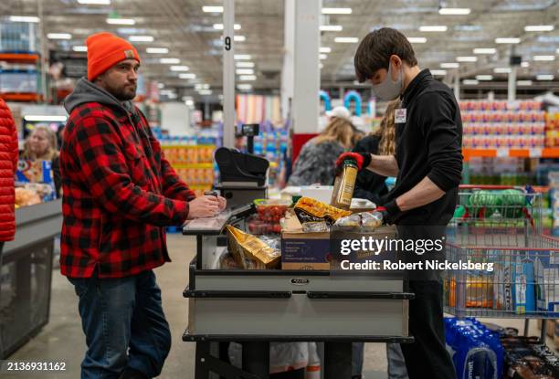 Customer moves through the check out lane with his groceries at a Costco Wholesale store on April 3, 2024 in Colchester, Vermont.