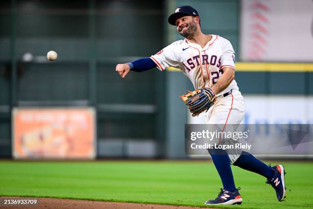 Jose Altuve of the Houston Astros fields the ball in the ninth inning against the Toronto Blue Jays at Minute Maid Park on April 03, 2024 in Houston,...