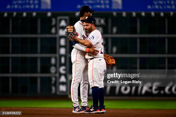Jose Altuve hugs Jeremy Pena of the Houston Astros after defeating the Toronto Blue Jays at Minute Maid Park on April 03, 2024 in Houston, Texas.