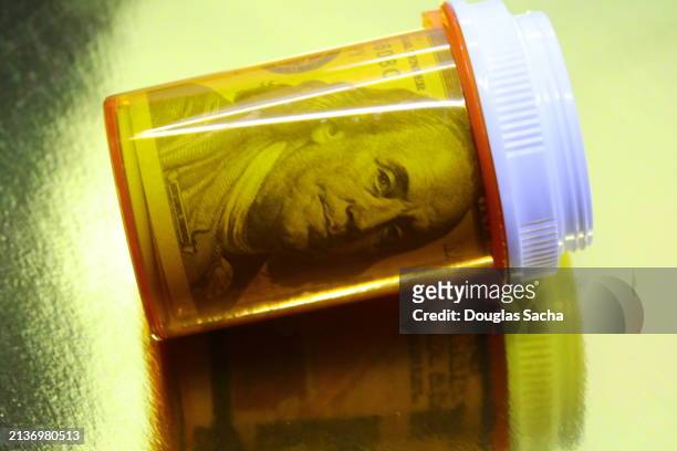 ben franklin portrait in a pharmacy pill bottle - ten us dollar note stock pictures, royalty-free photos & images