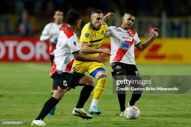 Norberto Briasco of Boca Juniors battles for the ball with Daniel Mancilla of Nacional Potosi and Marcos Andia of Nacional Potosi during the Copa...