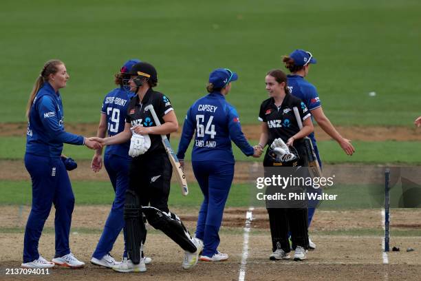 England and New Zealand shake hands following game two of the One Day International series between New Zealand and England at Seddon Park on April...