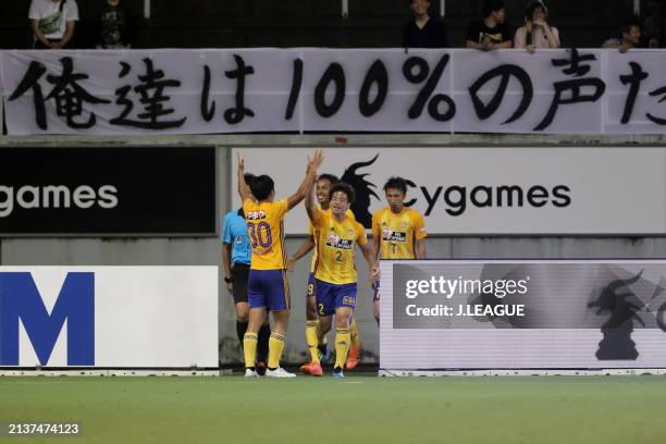 Takuma Nishimura of Vegalta Sendai celebrates with teammates after scoring the team's first goal during the J.League J1 match between Sagan Tosu and...