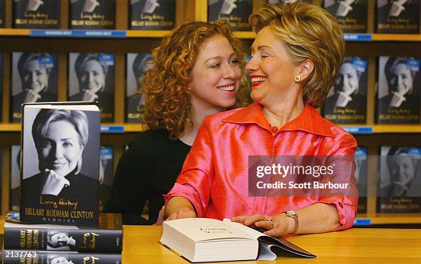 Hillary Rodham Clinton talks with her daughter Chelsea Clinton as she signs copies of her autobiography 'Living History' July 5, 2003 in Oxford,...