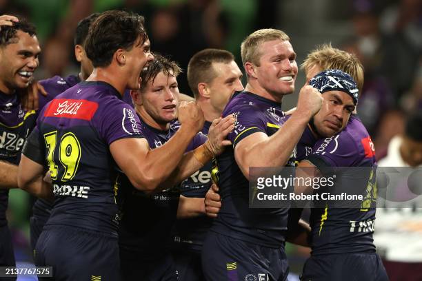 Jahrome Hughes of the Storm celebrates with team mates after scoring a try during the round five NRL match between Melbourne Storm and Brisbane...