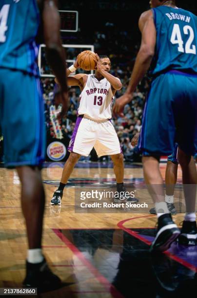 Doug Christie, Shooting Guard and Small Forward for the Toronto Raptors holds up play to make a pass during the NBA Central Division basketball game...