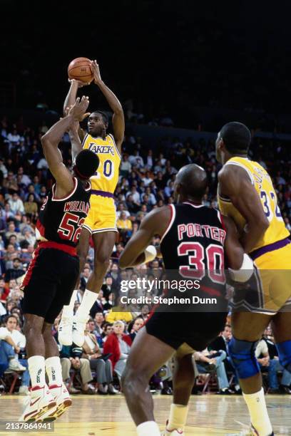 Terry Teagle, Shooting Guard and Small Forward for the Los Angeles Lakers rises to make a jump shot to the basket over Buck Williams of the Portland...