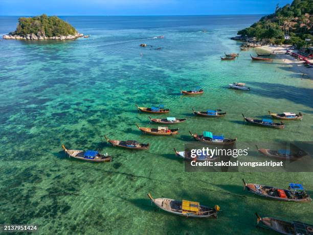 scenic view longtail boats moored on the beach during sunrise in koh lipe in thailand - ko lipe stock pictures, royalty-free photos & images