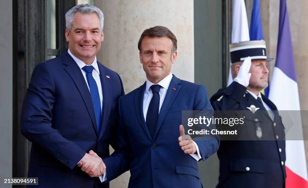 French President Emmanuel Macron welcomes Austria's Chancellor Karl Nehammer prior to a working lunch at the Elysee on April 04, 2024 in Paris,...