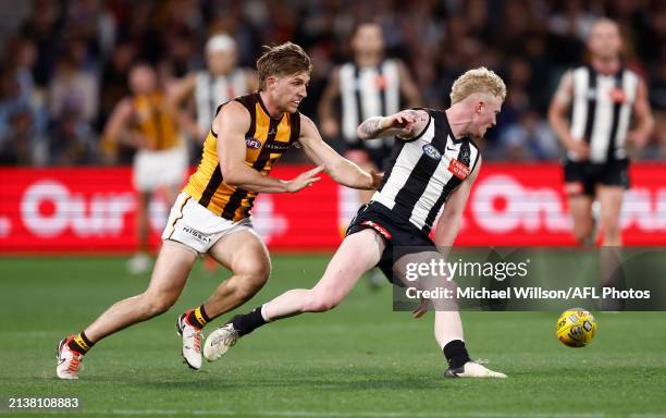 John Noble of the Magpies and Dylan Moore of the Hawks compete for the ball during the 2024 AFL Round 04 match between the Collingwood Magpies and...