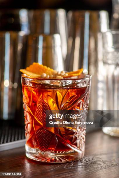 bartender prepares cocktail at the bar counter - bitter stock pictures, royalty-free photos & images