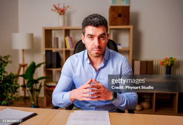 businessman having online virtual meeting call on laptop looking at screen sitting at table in co-working creative office, professional manager talking to employees - middle eastern male on phone isolated stock pictures, royalty-free photos & images