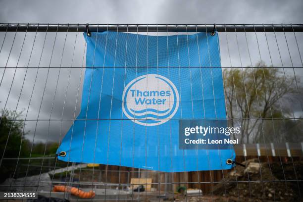 The Thames Water logo is seen on protective fencing around a pipework replacement site on April 04, 2024 in London, England. Last week, Thames Water...