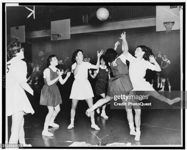 View of on-court action during a women's basketball game, New York, New York, circa 1961. Among those pictured are Ann Santorelli , of St John's...