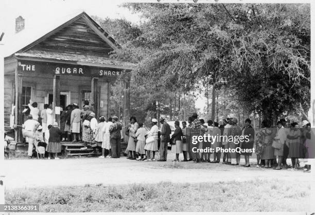 Following the passage of the Voting Rights Act of 1965, people line up to vote at the Sugar Shack store, Peachtree, Alabama, May 3, 1966.