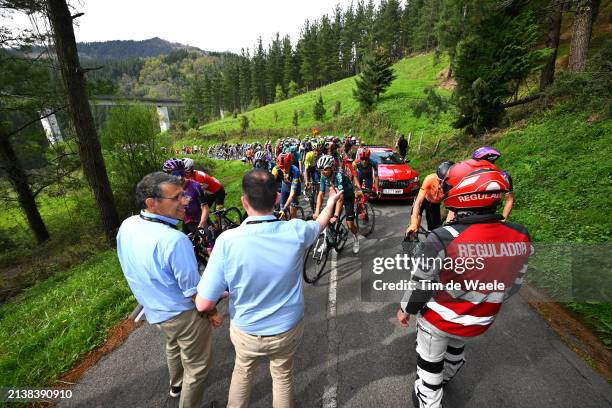 Commissaires and a general view of the peloton waiting at Olaeta after the neutralisation of the race due to a multiple crash during the 63rd Itzulia...