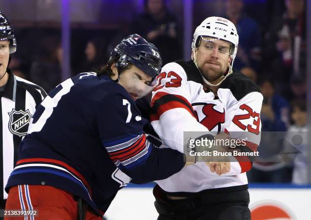 Kurtis MacDermid of the New Jersey Devils fights with Matt Rempe of the New York Rangers during the first period at Madison Square Garden on April...