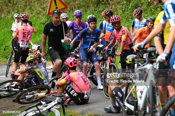 Quentin Pacher of France and Team Groupama - FDJ and a general view of the peloton waiting at Olaeta after the neutralisation of the race due to a...