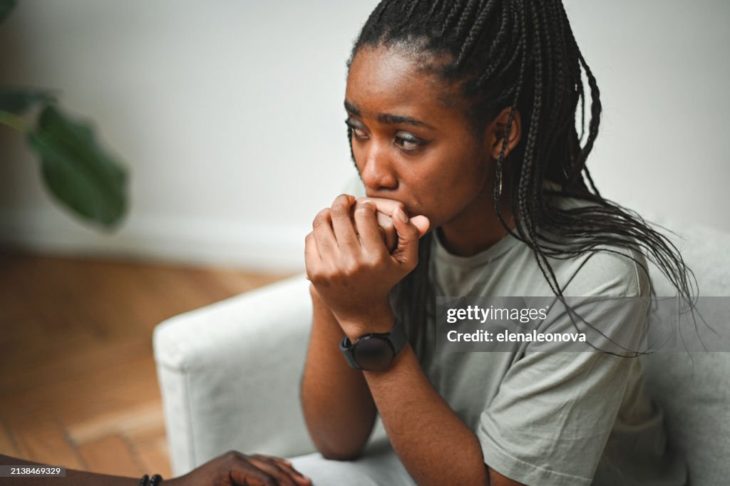 Young woman sitting on the floor in sadness
