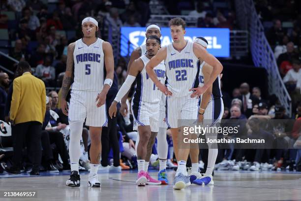 Paolo Banchero, Franz Wagner and Gary Harris of the Orlando Magic react during a game against the New Orleans Pelicans at the Smoothie King Center on...