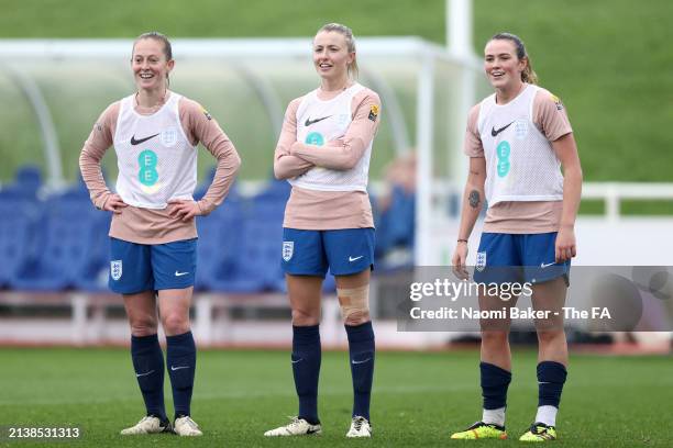 Keira Walsh, Leah Williamson and Grace Clinton of England look on during a training session at St Georges Park on April 04, 2024 in...