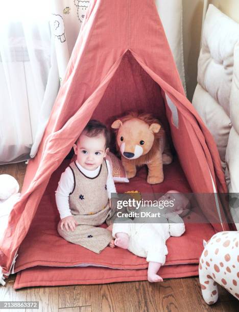 two infant sisters having fun in tent at home - arab people stock pictures, royalty-free photos & images