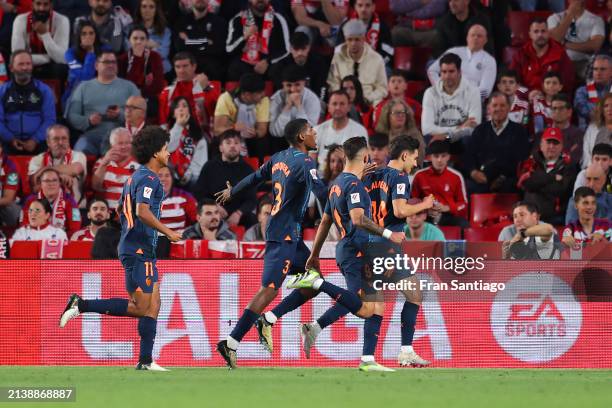 Andre Almeida of Valencia CF celebrates scoring his team's first goal with teammates during the LaLiga EA Sports match between Granada CF and...