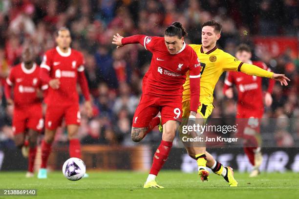 Darwin Nunez of Liverpool runs with the ball whilst under pressure from James McAtee of Sheffield United during the Premier League match between...