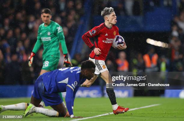 Alejandro Garnacho of Manchester United collects the ball after scoring their first goal during the Premier League match between Chelsea FC and...